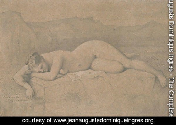 Naked woman lying on a rock